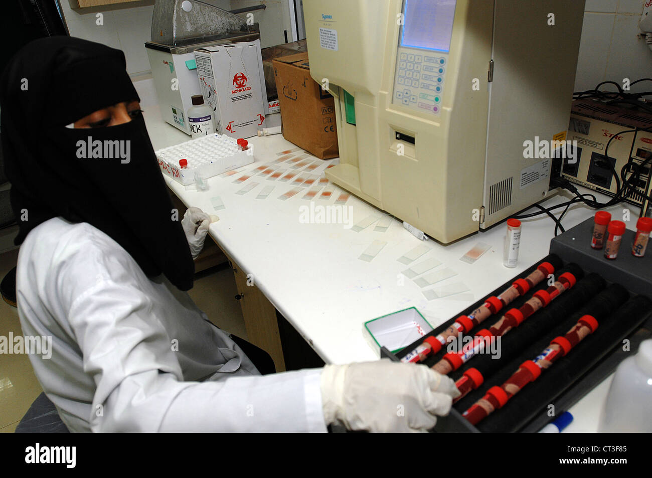 Sample Taker Lab A laboratory technician prepares to test blood samples taken from a ...
