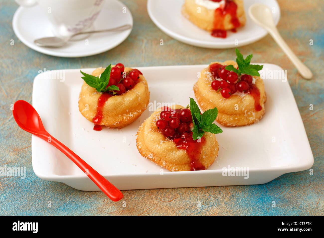 Little sponge cakes with cream and red currants. Recipe available, Stock Photo