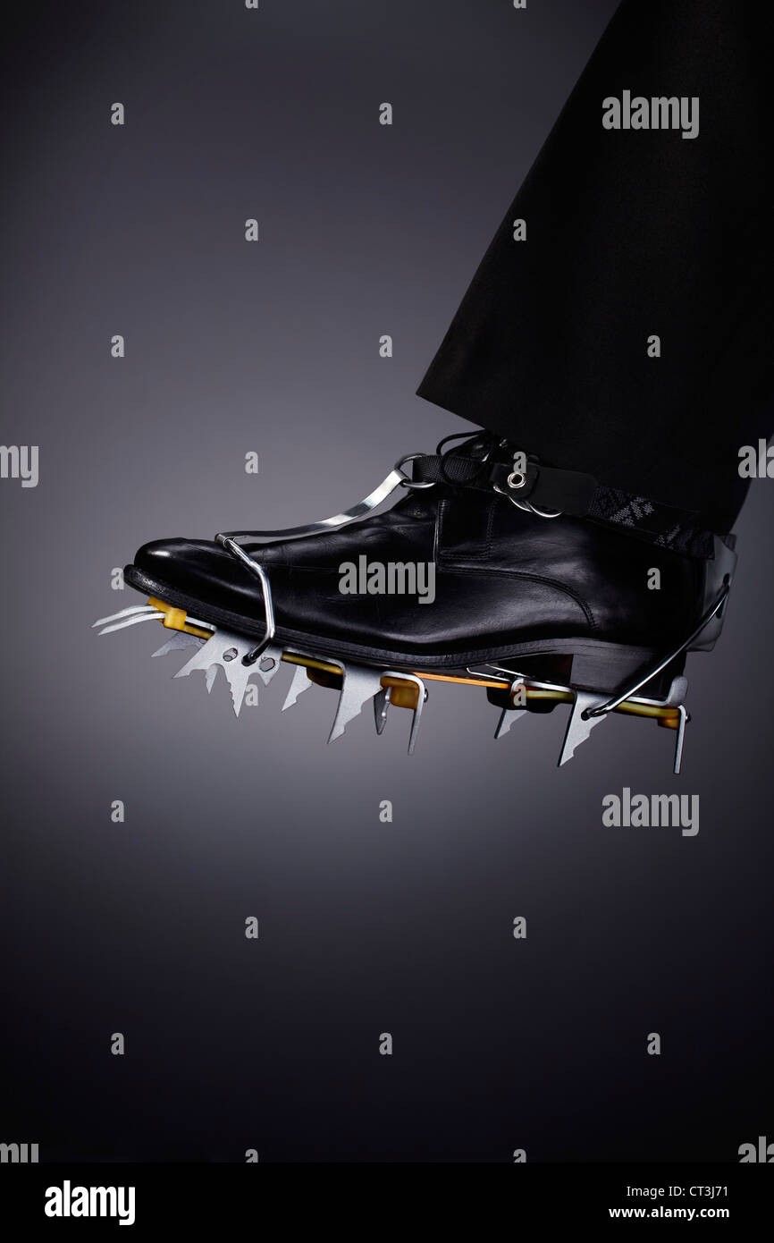 Businessman wearing spikes on shoe Stock Photo Alamy