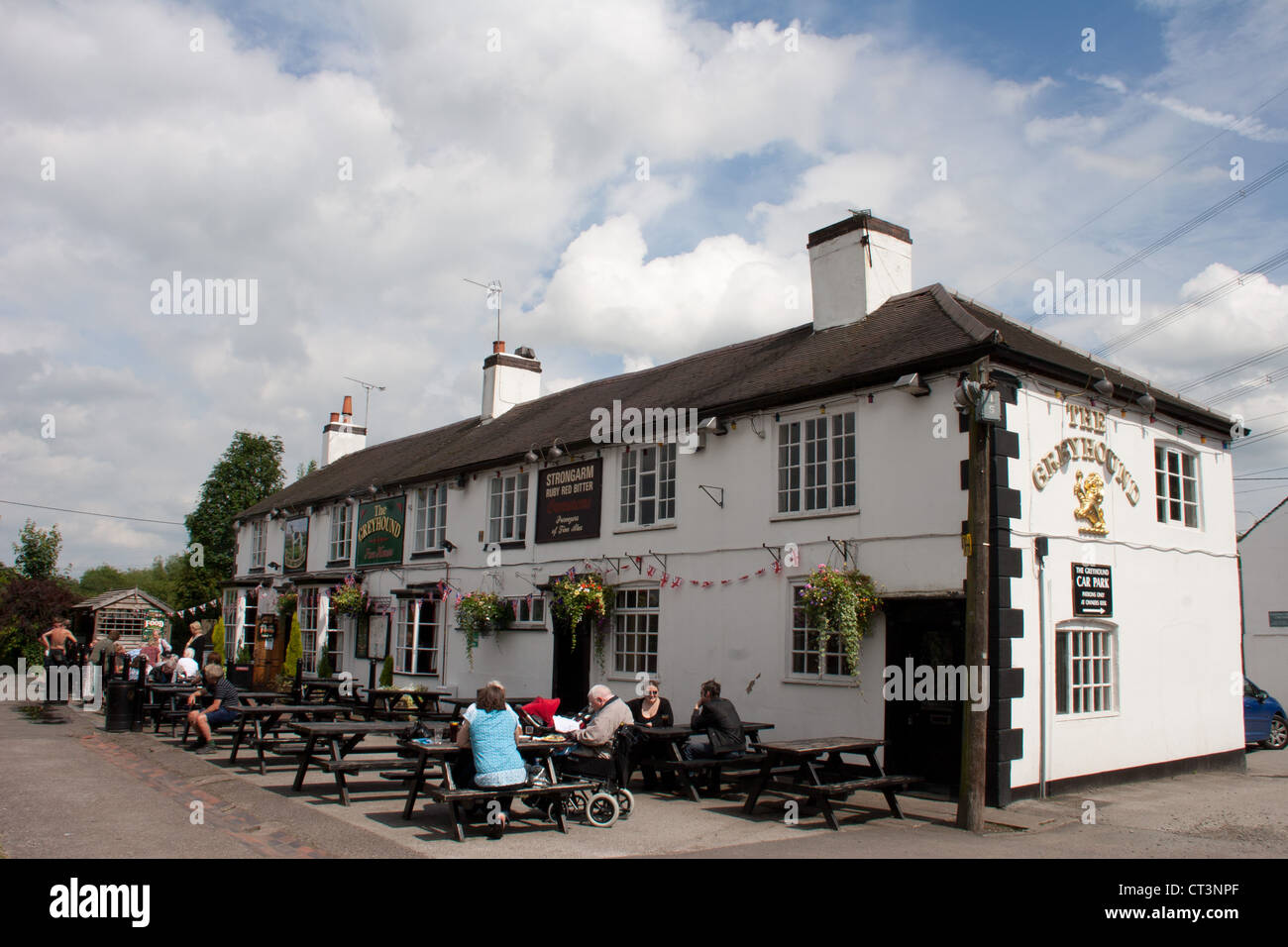 This white Greyhound pub with eating facilities both indoors and outdoors is in Hawkesbury at the junctions of two canals. Stock Photo