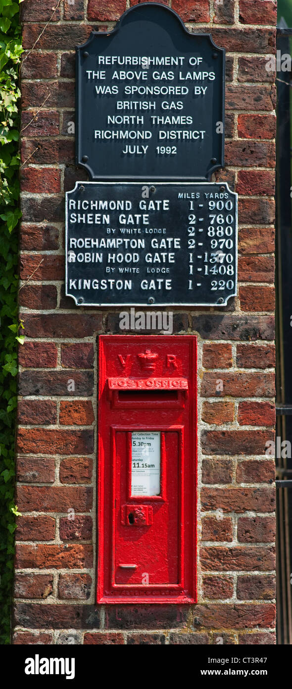 Old red post box and distance sign at the entrance to Ham Gate into