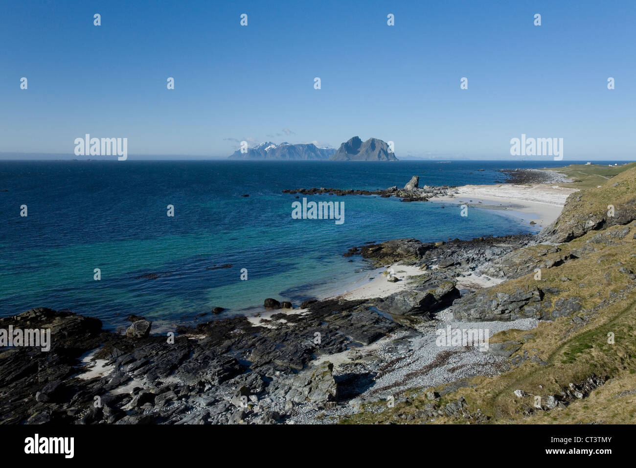 The coastline of Vaeroy in the Lofoten Islands, Norway, with Moskenesøya visible in the distance Stock Photo