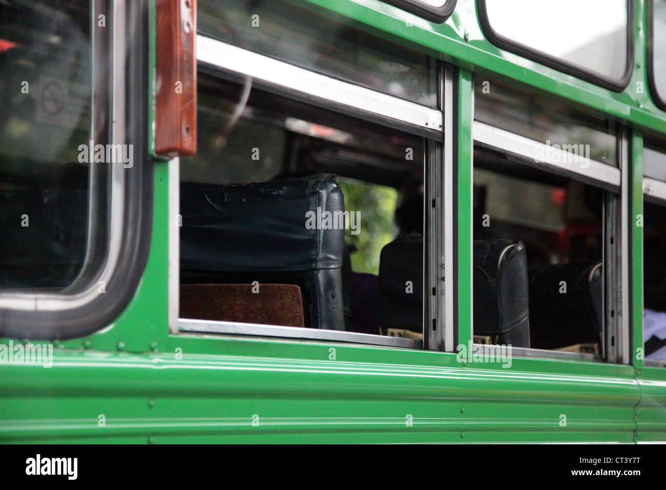 It's a photo of a part of a green bus in Bangkok in Thailand. It's a public transport with no air conditioned, which is hard Stock Photo