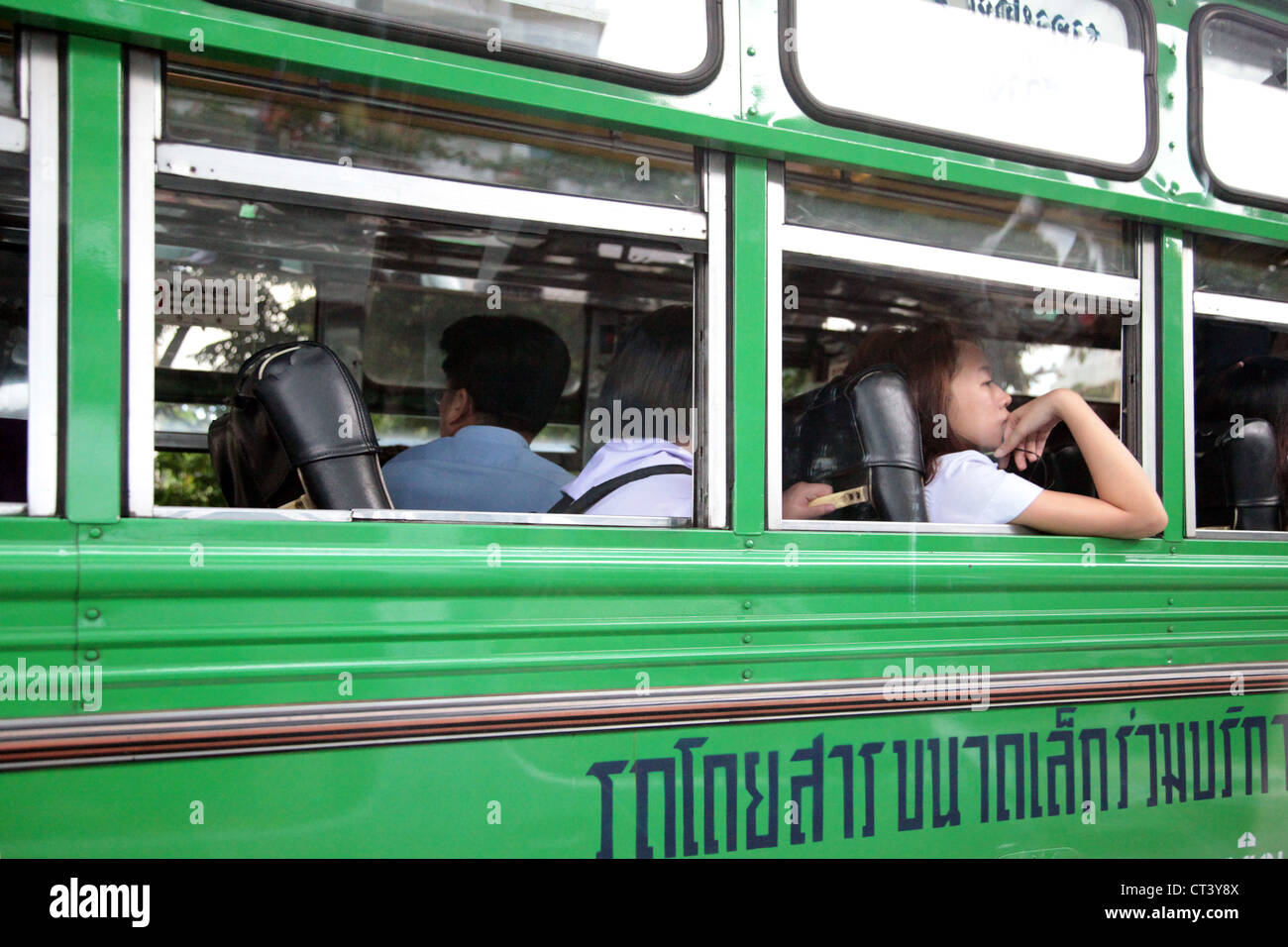 It's a photo of a part of a green bus in Bangkok in Thailand. It's a public transport with no air conditioned, which is hard Stock Photo