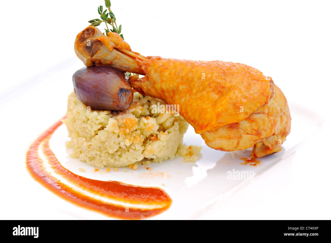 prepared drumstick with onion and cereals on white plate Stock Photo