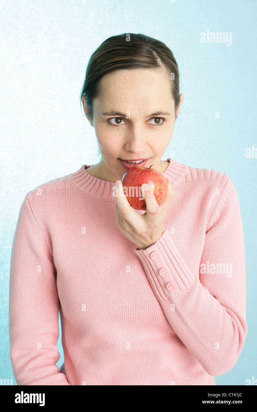 WOMAN EATING FRUIT Stock Photo