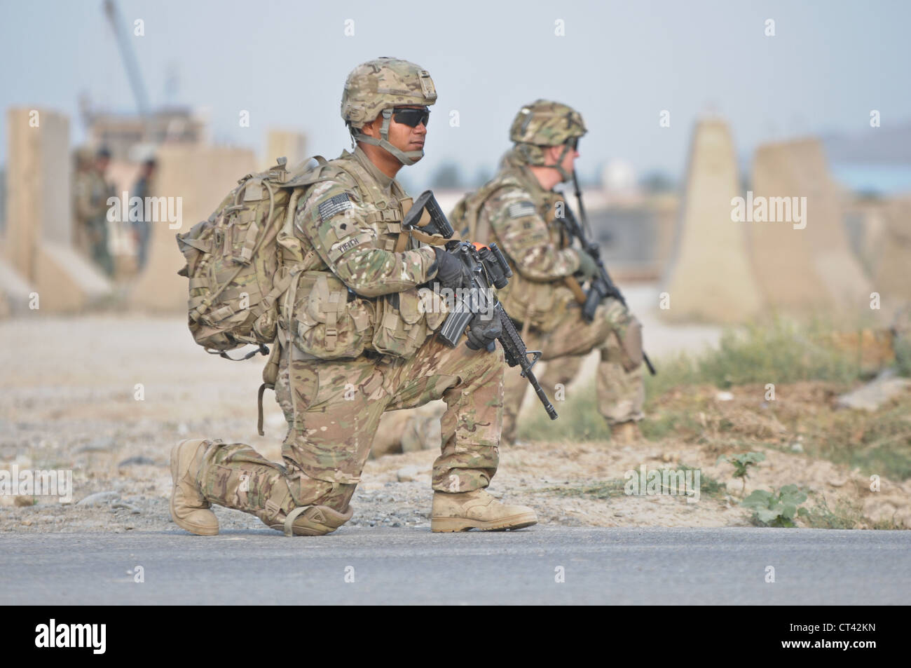 A US Airborne paratroopers conduct a security patrol outside of Forward Operating Base Salerno July 7, 2012 in Kunday, Afghanistan. Soldiers provided security for a midwife program held at a girls school in the village. Stock Photo