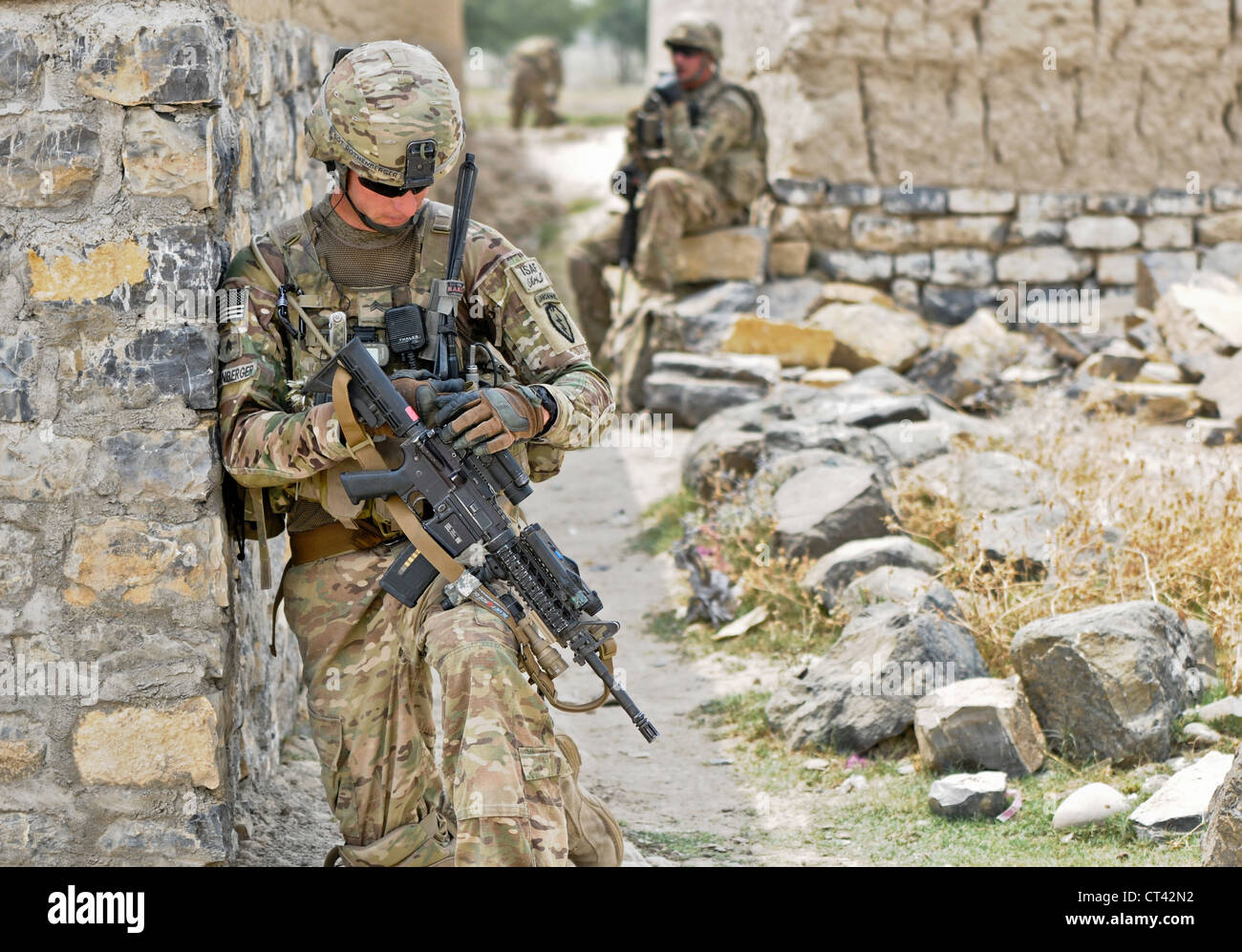 A US Airborne paratroopers conduct a security patrol outside of Forward Operating Base Salerno July 7, 2012 in Kunday, Afghanistan. Soldiers provided security for a midwife program held at a girls school in the village. Stock Photo