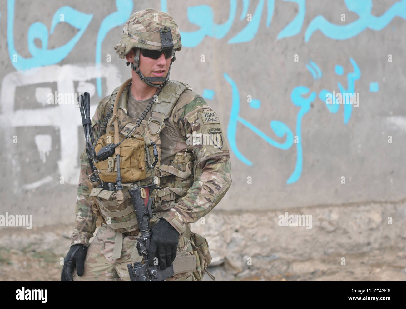 A US Airborne paratrooper conducts a security patrol outside of Forward Operating Base Salerno July 7, 2012 in Mangas, Afghanistan. Soldiers provided security for a midwife program held at a girls school in the village. Stock Photo