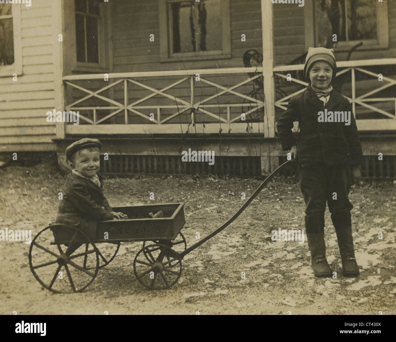 Circa 1890s antique photograph, two young boys pulling a wagon ...