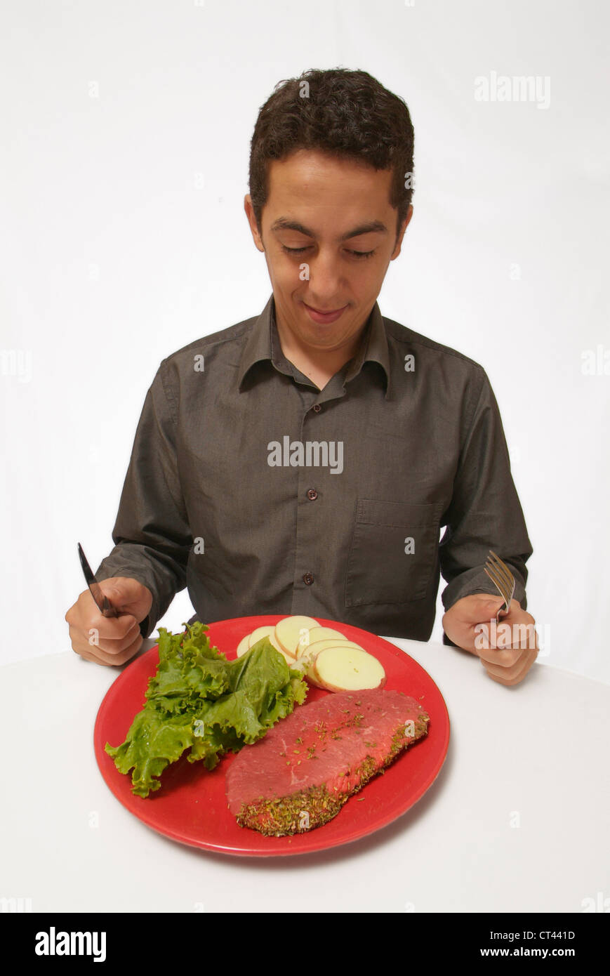 MAN EATING MEAT Stock Photo - Alamy