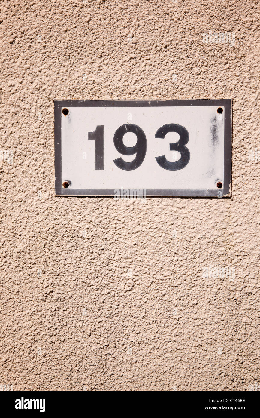 Number '193' on a plate attached to a wall. Stock Photo