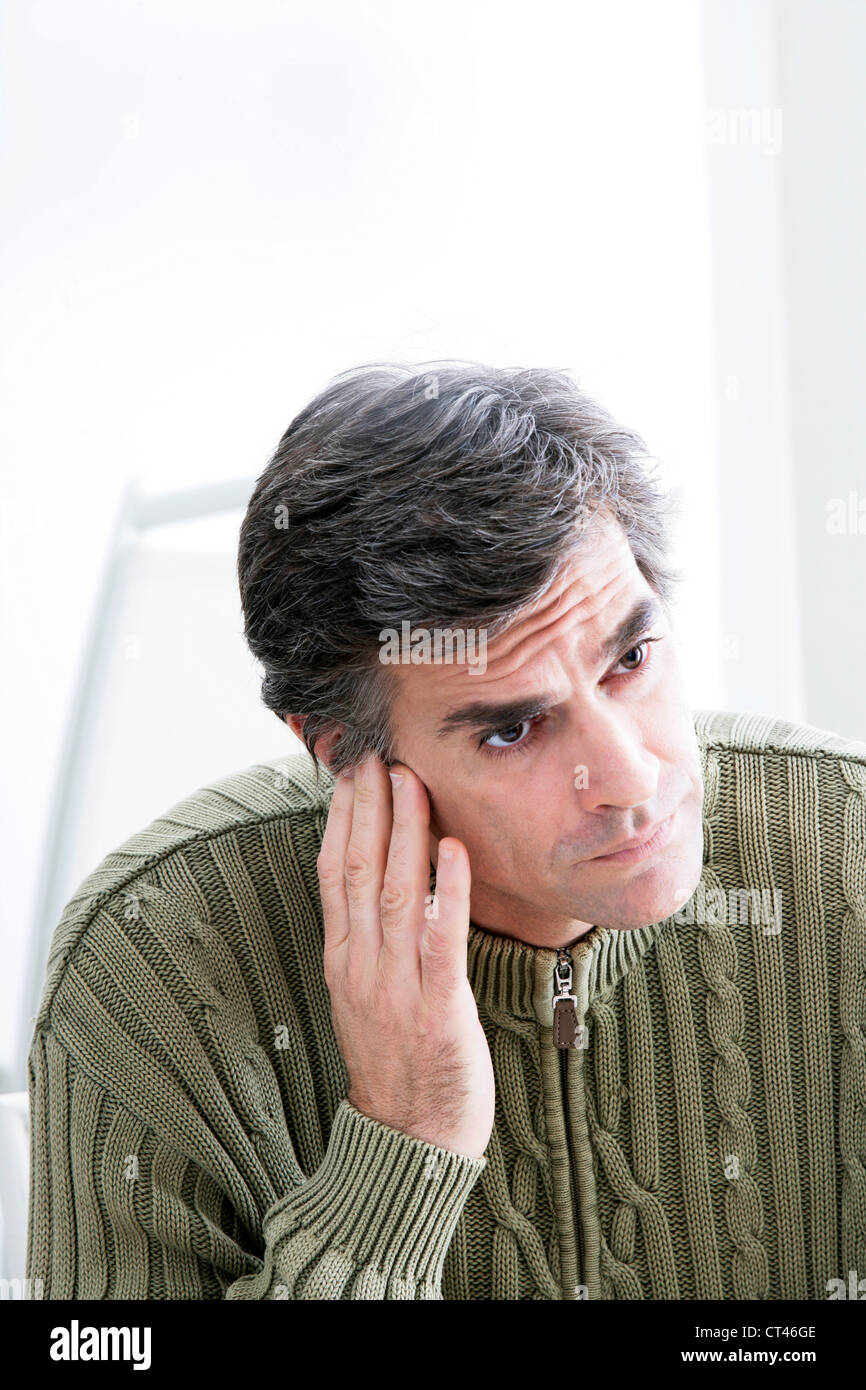 EAR PAIN IN A MAN Stock Photo