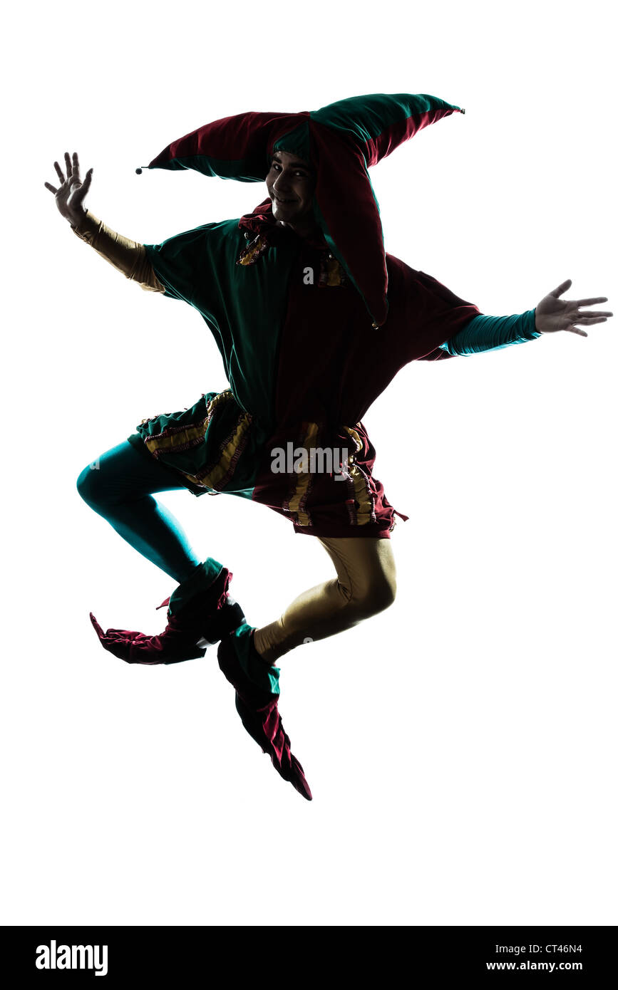 one caucasian man in jester costume jumping silhouette in studio isolated on white background Stock Photo
