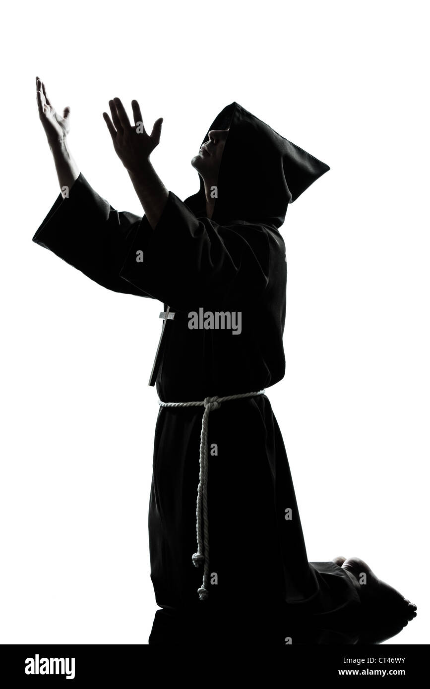 one caucasian man priest praying silhouette in studio isolated on white background Stock Photo