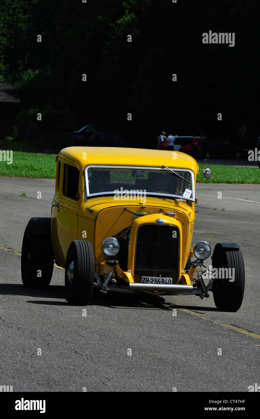 A yellow hotrod. Space for text on the dark background behind Stock Photo