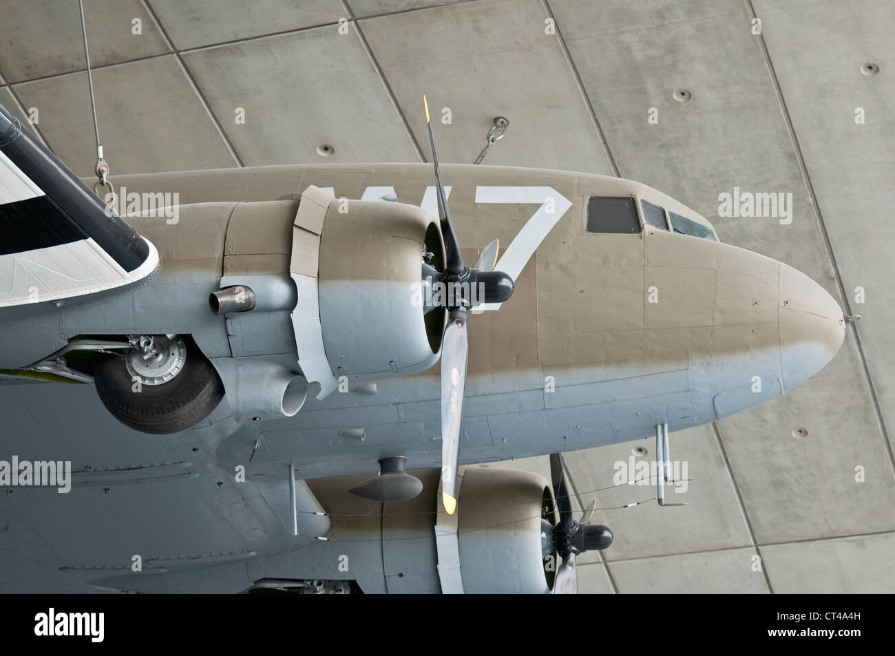 Douglas DC3 Dakota plane on display hanging from the ceiling of the American Air Museum at IWM Duxford Stock Photo