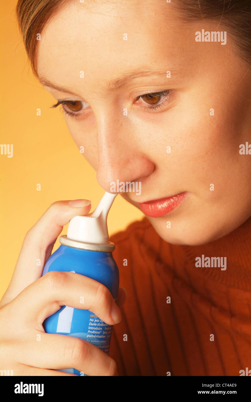 WOMAN USING NOSE SPRAY Stock Photo Alamy