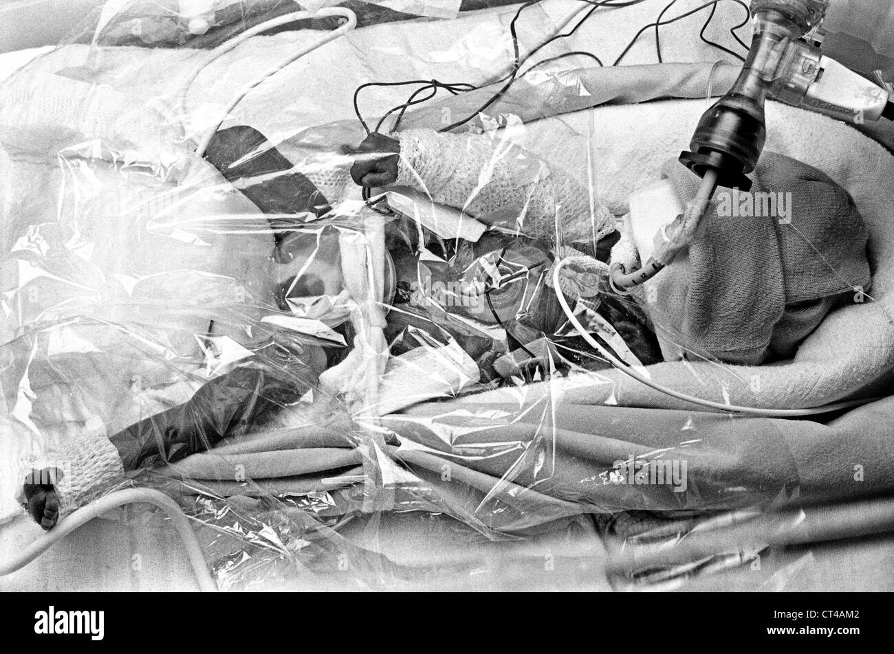 Baby lying in bed Black and White Stock Photos & Images Alamy