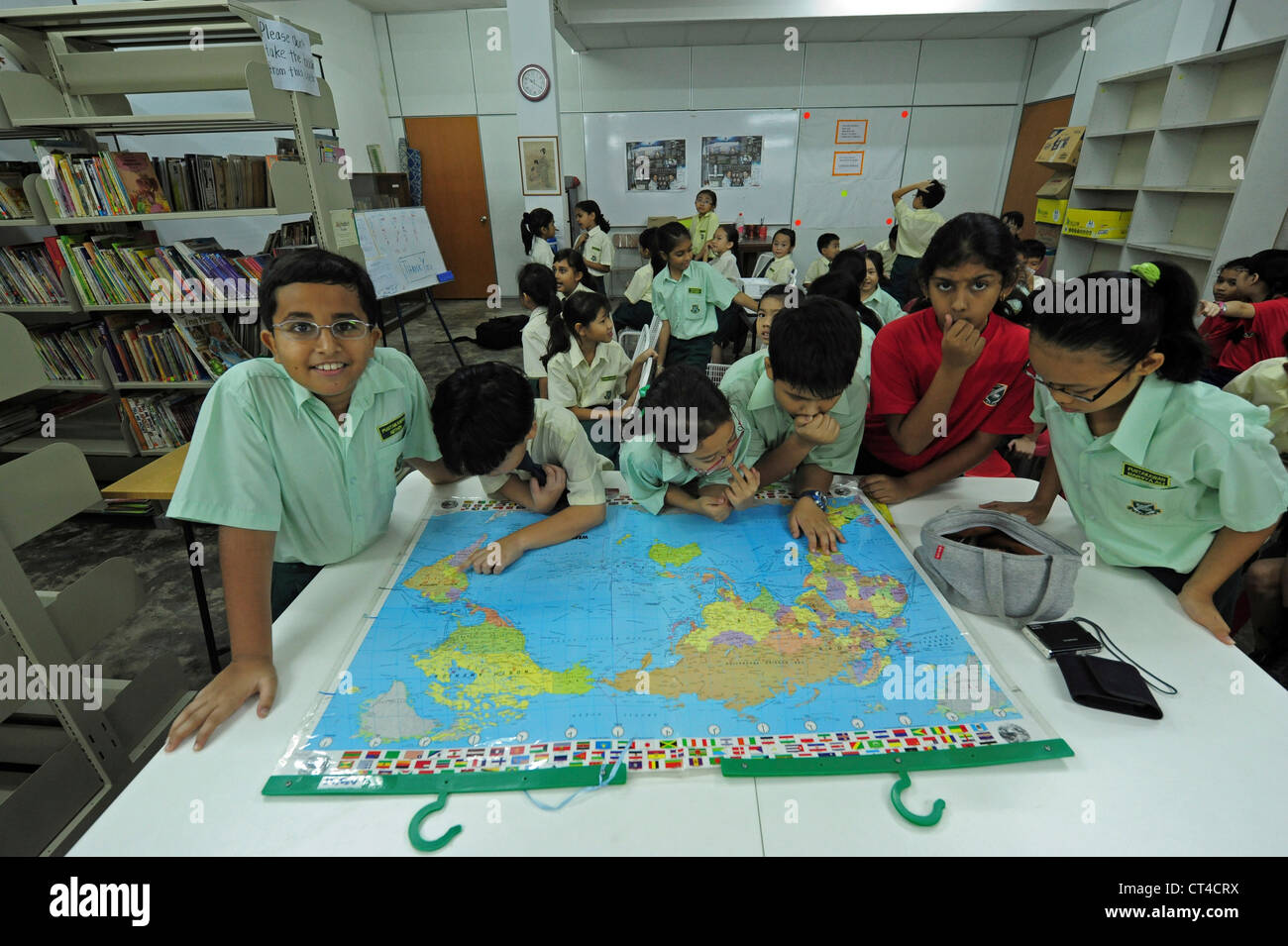 Malaysia, Kuala Lumpur, children looking at world map Stock Photo