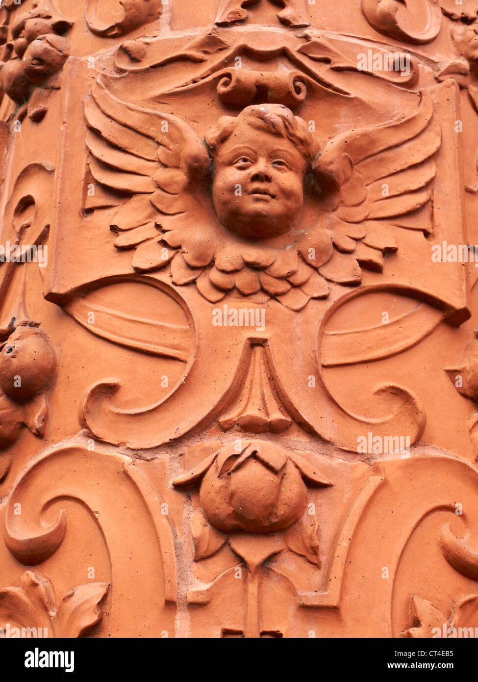 Carved brickwork and tarracotta architectural detail of face on Peel Building University of Salford UK Stock Photo