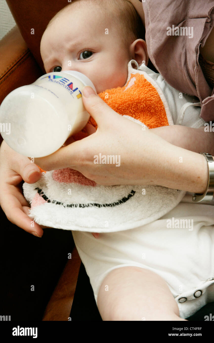 INFANT DRINKING FROM BABY BOTTLE Stock Photo Alamy