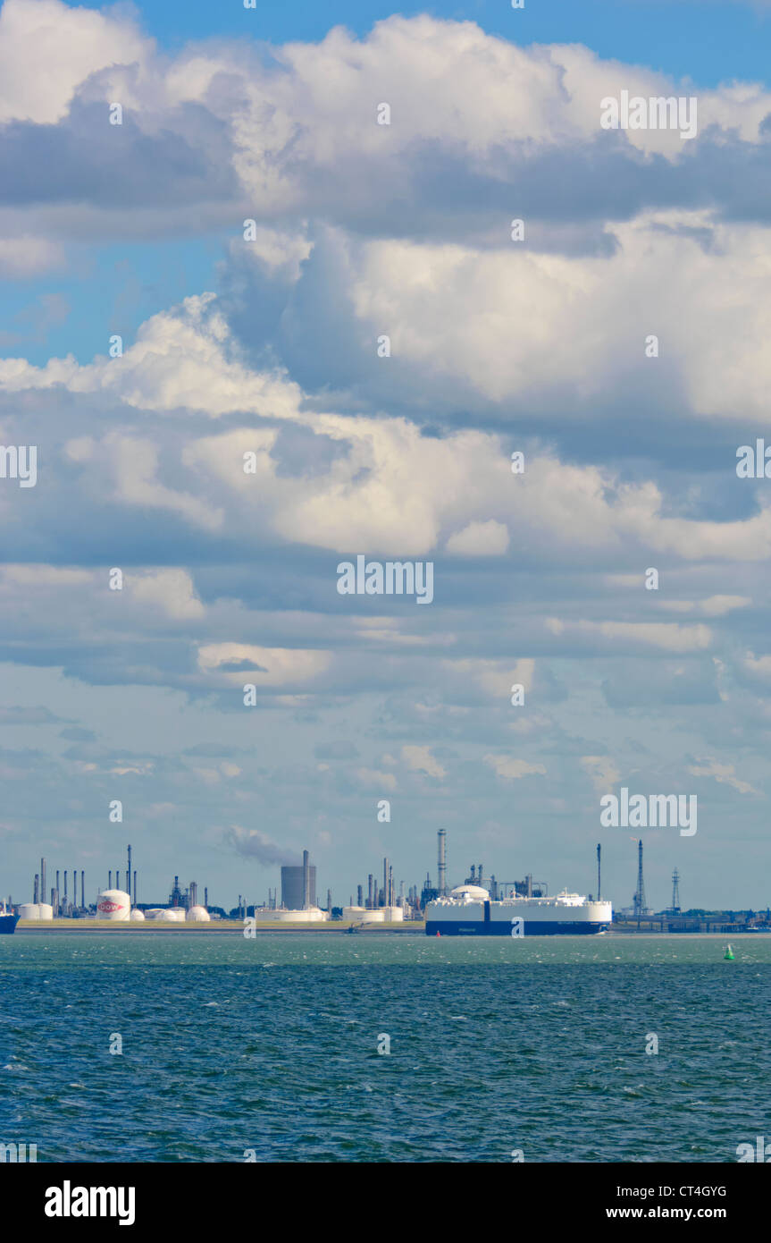 Passing ships in front of the plant of Dow Chemical Company. Terneuzen, Zeeland, The Netherlands. Stock Photo