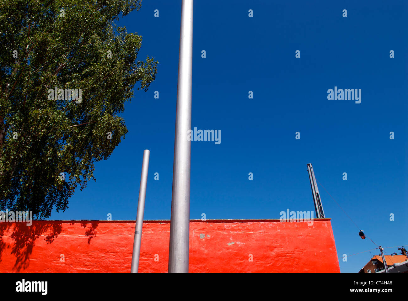 RED WALL BEHIND METAL POLES Stock Photo Alamy