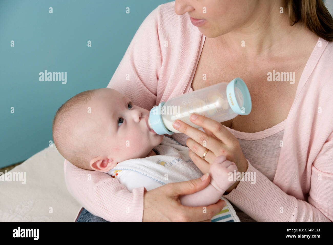 INFANT DRINKING FROM BABY BOTTLE Stock Photo Alamy