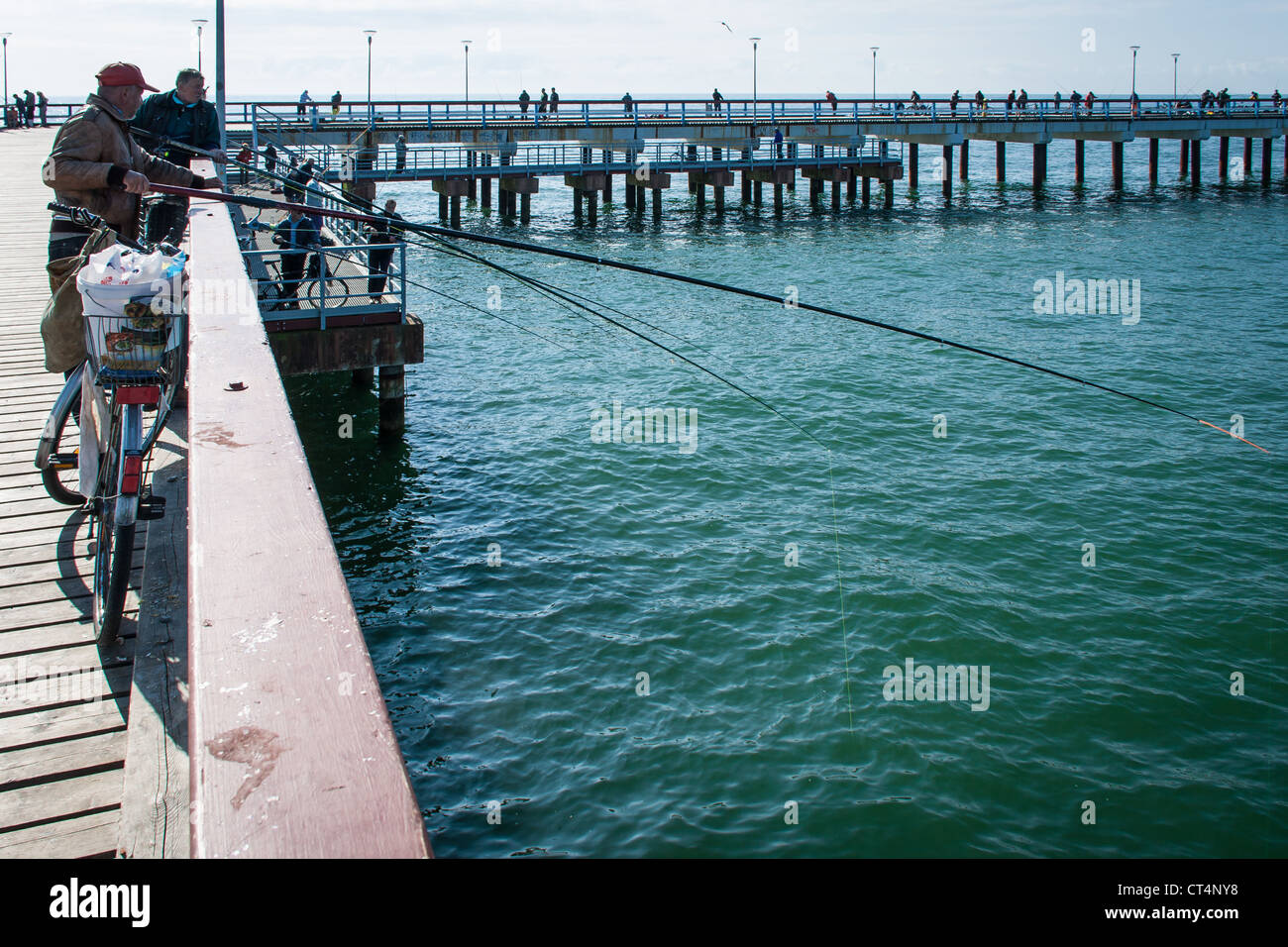 fishing rod hanging over the side of a pier at blackpool uk Stock Photo -  Alamy