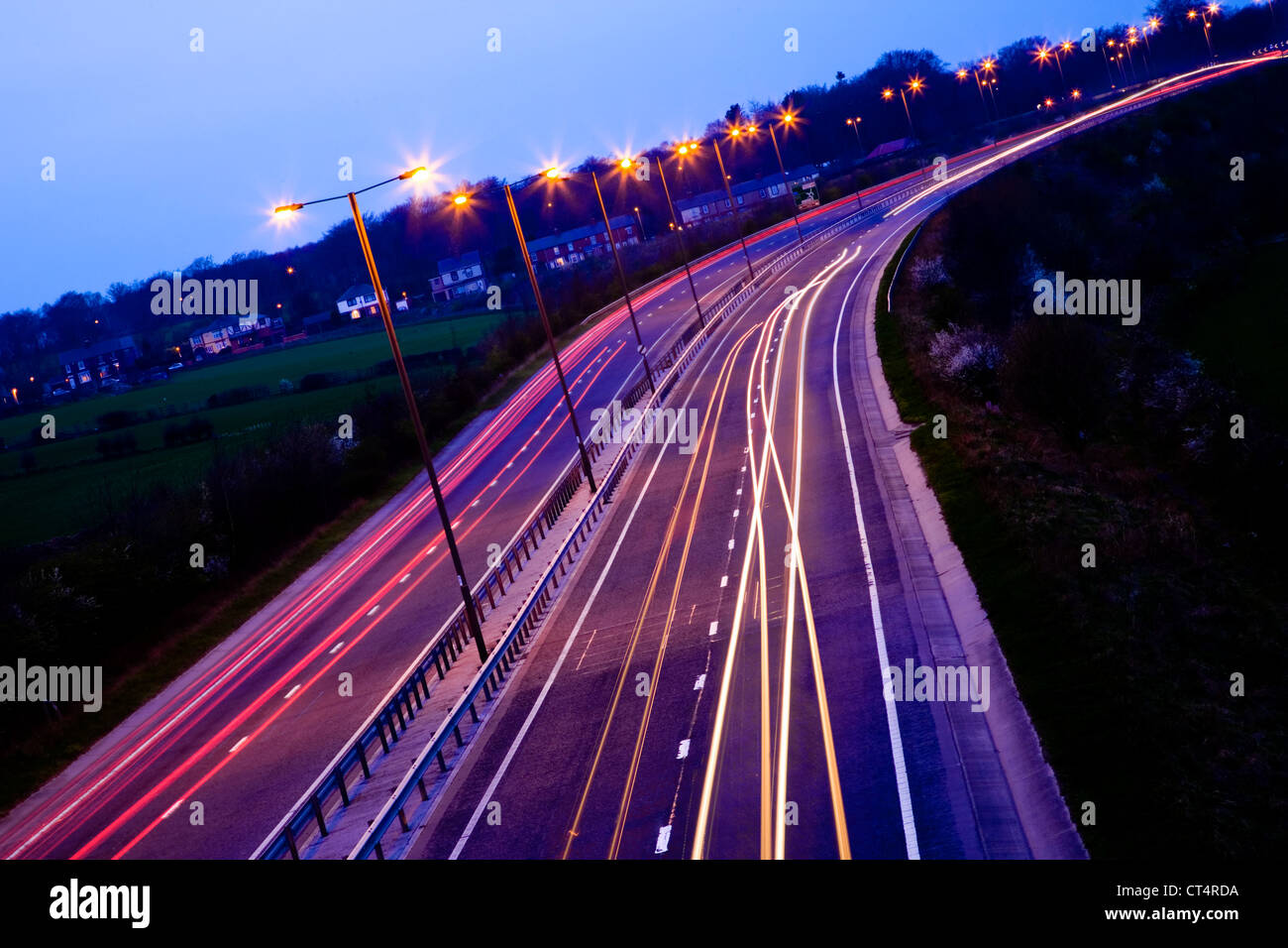Road at night with traffic trails and street lights Stock Photo