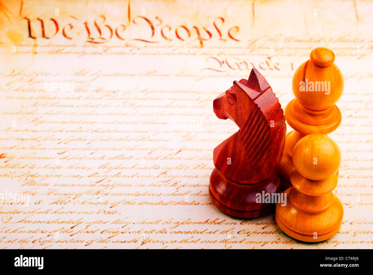 Chess pieces and hand written copy of American Constitution. Concepts of equality and justice. Stock Photo