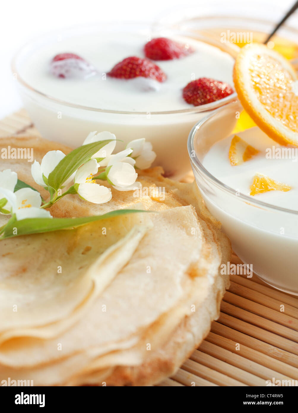 Golden pancakes and two fruit yogurt. Delicious Stock Photo