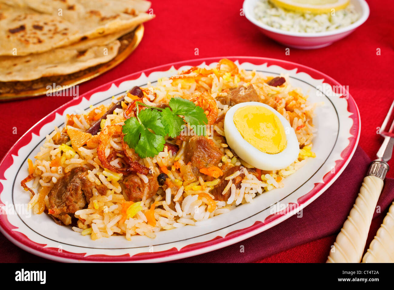 A festive Indian curry, lamb biryani with crisp onion rings, coriander