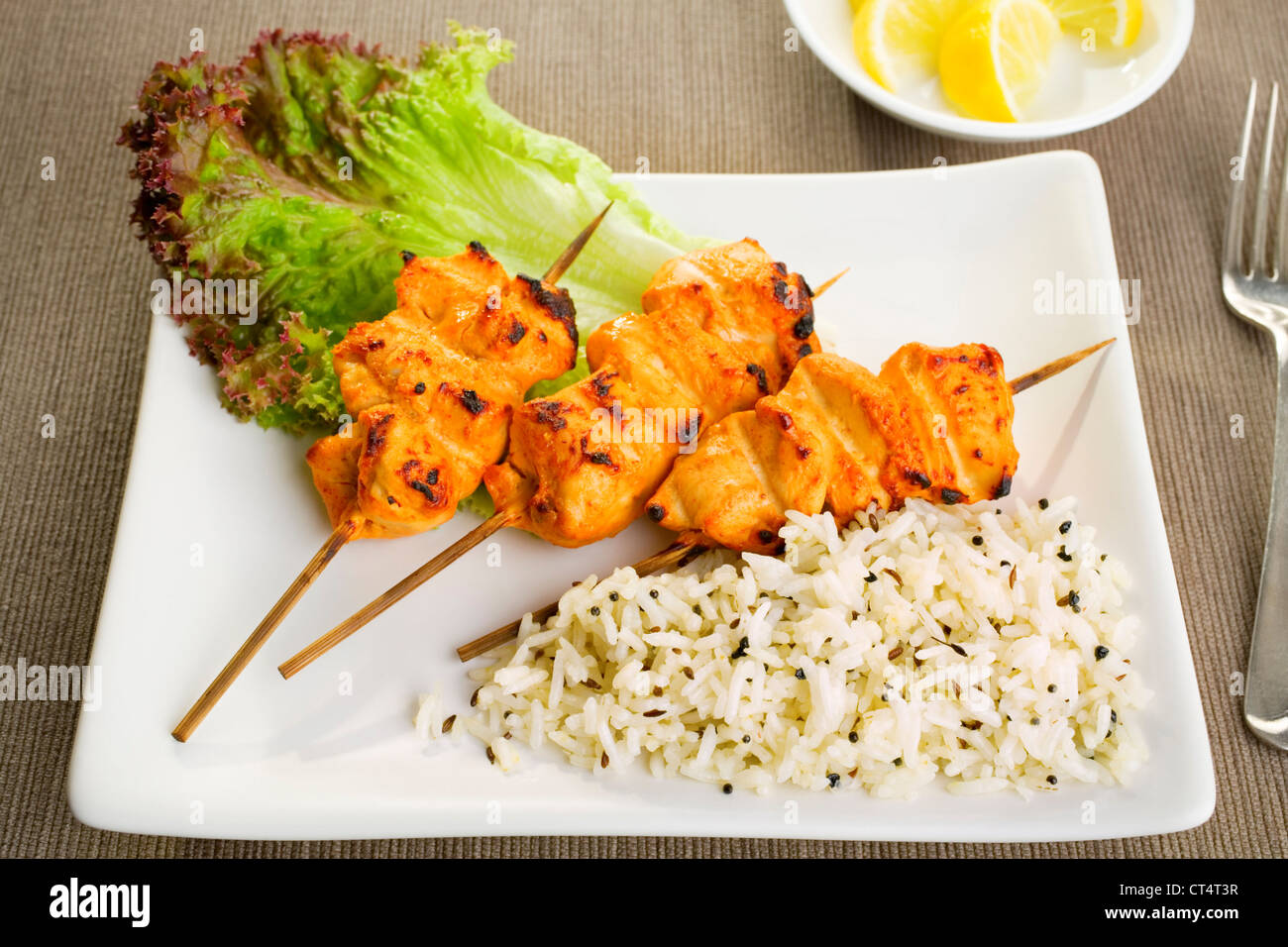 Tandoori chicken with basmati rice and salad. Stock Photo