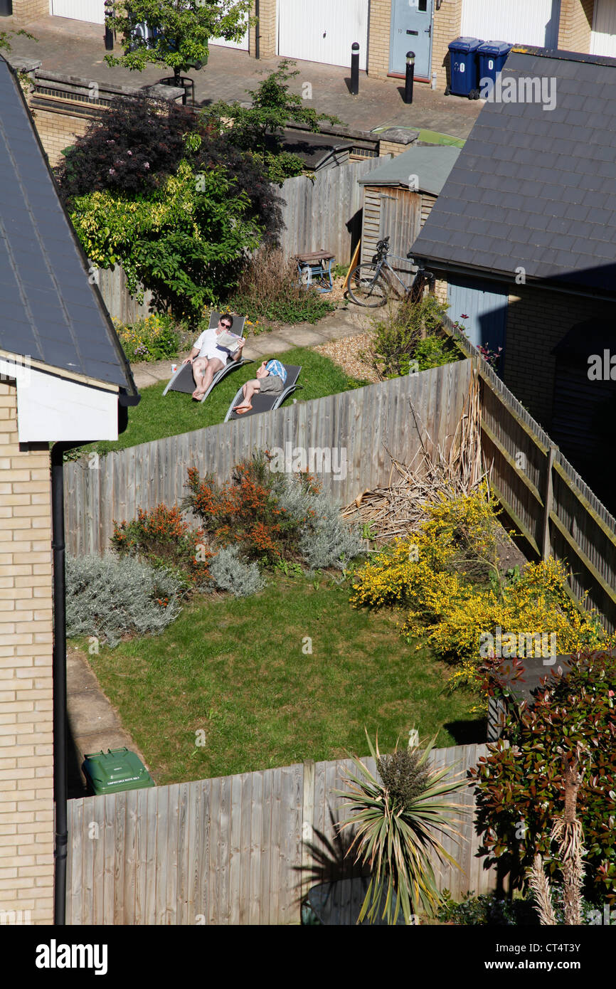 Couple in a garden in a suburbian cul-de-sac in Cambridge, England, UK Stock Photo