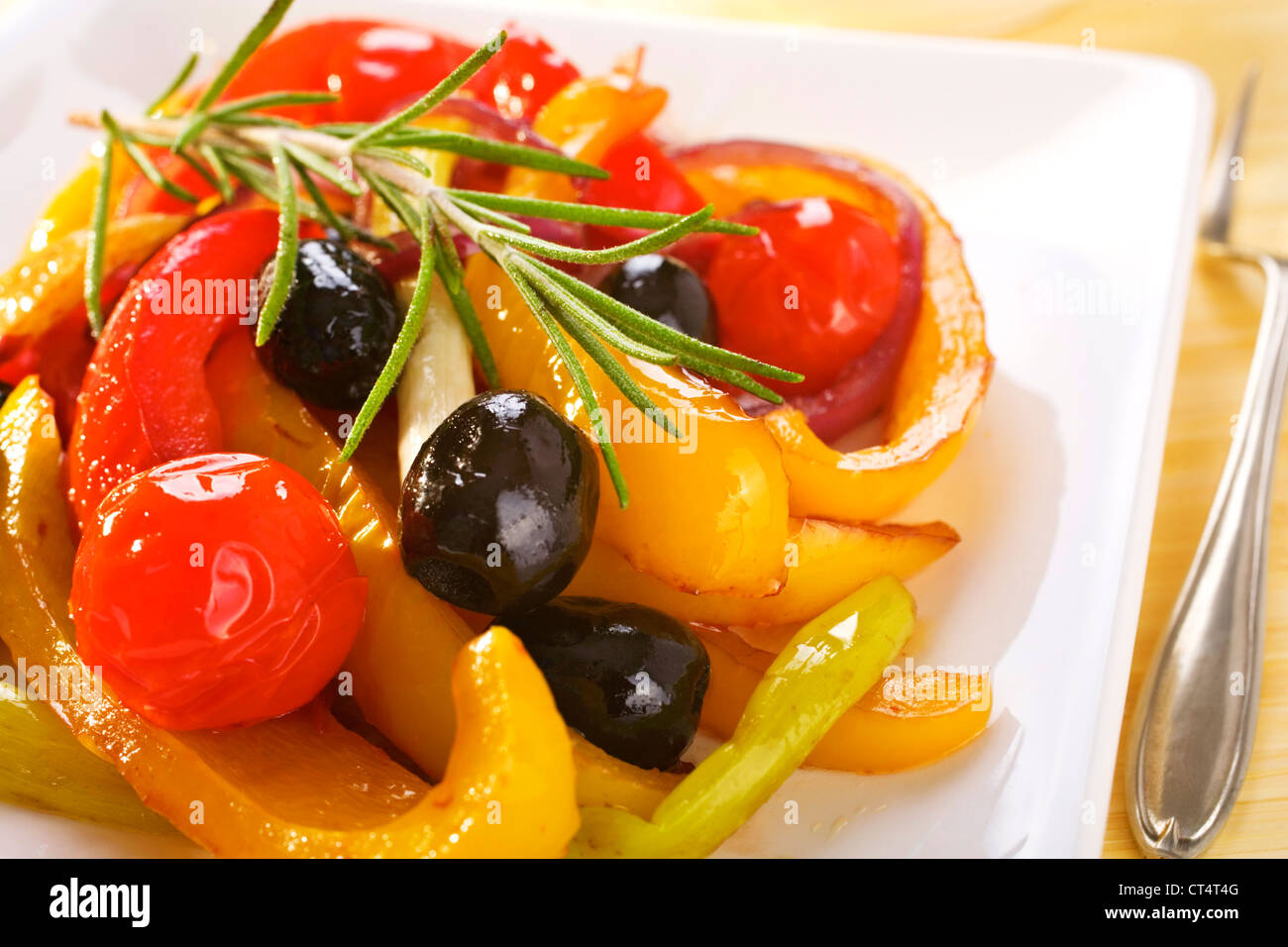 A Spanish vegetable dish, baked red and yellow peppers with olives