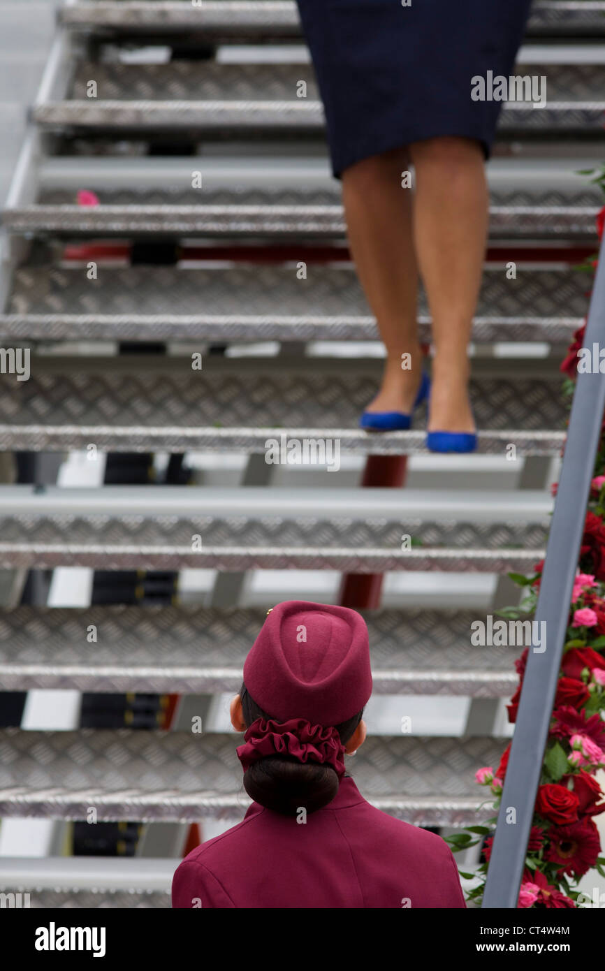 Cabin crew hostess at the bottom of steps a Qatar Airways Boeing 787 at the Farnborough Air Show, UK. Stock Photo