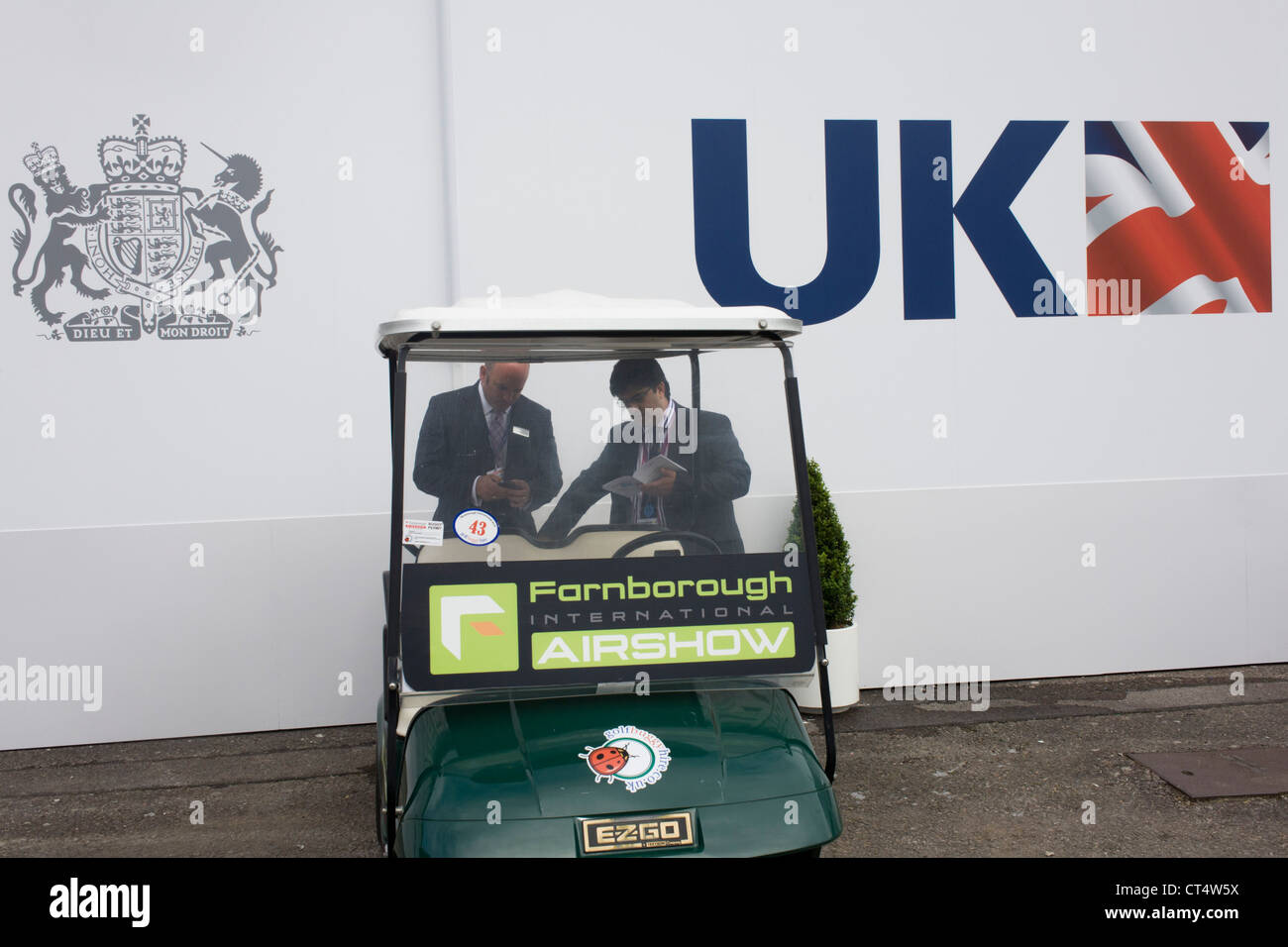 Delegates discuss business outside the UK exhibition chalet at the Farnborough Air Show. Stock Photo