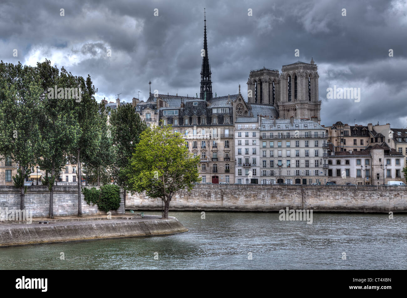 Traditional parisian buildings along Seine river and Notre Dame de Paris Cathedral on background in Paris, France. Stock Photo
