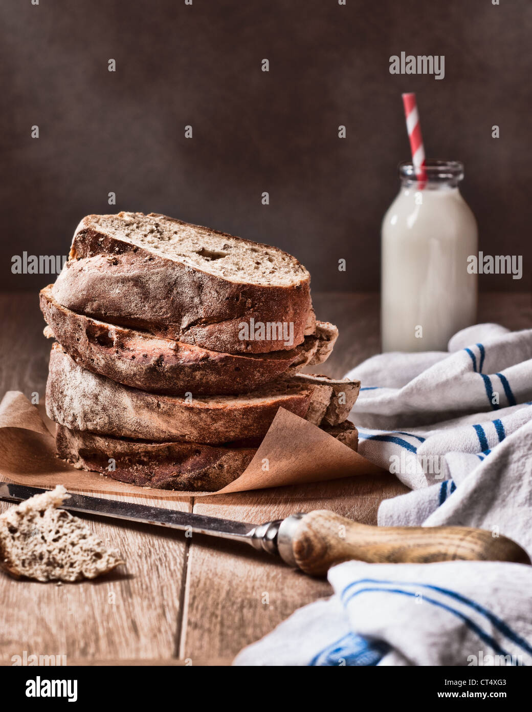 Slices of fresh crusty bread with knife Stock Photo