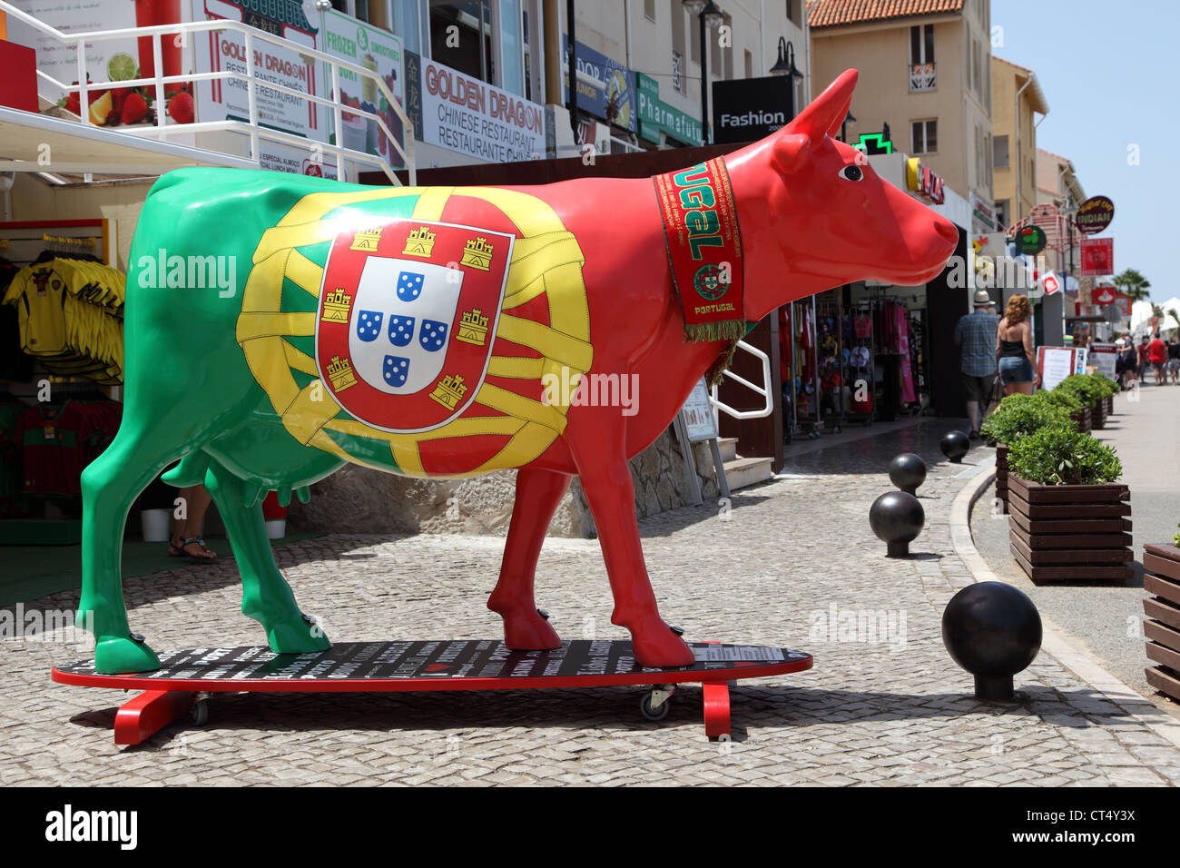Cow on surfing board painted in national Portuguese colors. Vilamoura Marina, Algarve Portugal Stock Photo