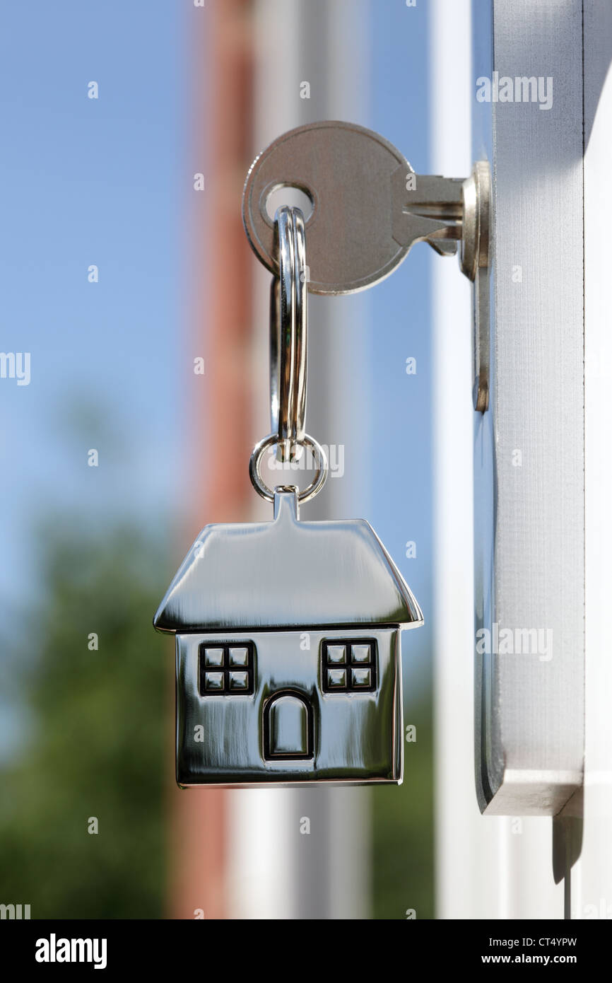 House key in the door Stock Photo