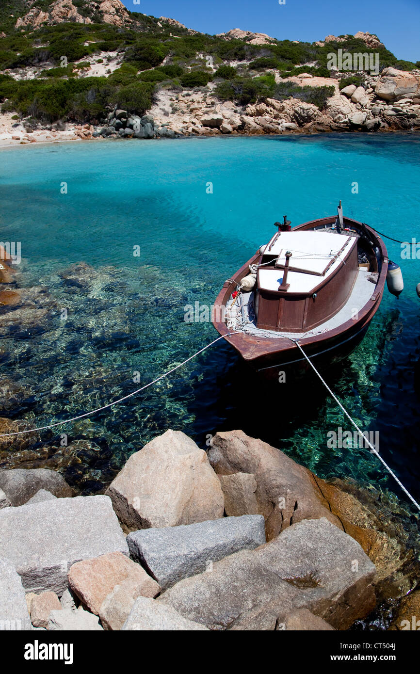 Boat and wharf, beach and sea in Cala Corsara, archipelago La Maddalena