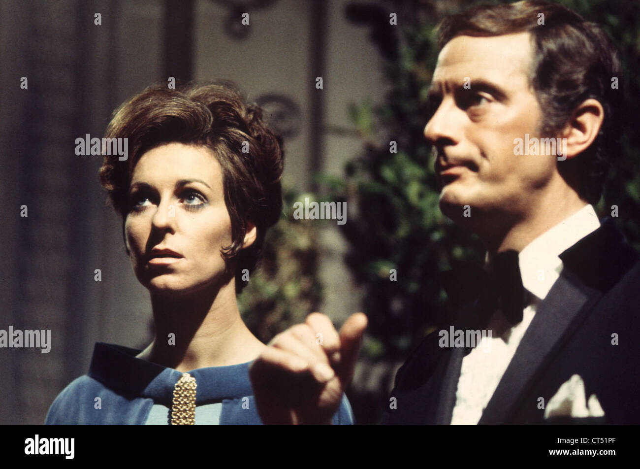 Ros Drinkwater and Francis Mattews during filming of Paul Temple. c.1970 Stock Photo