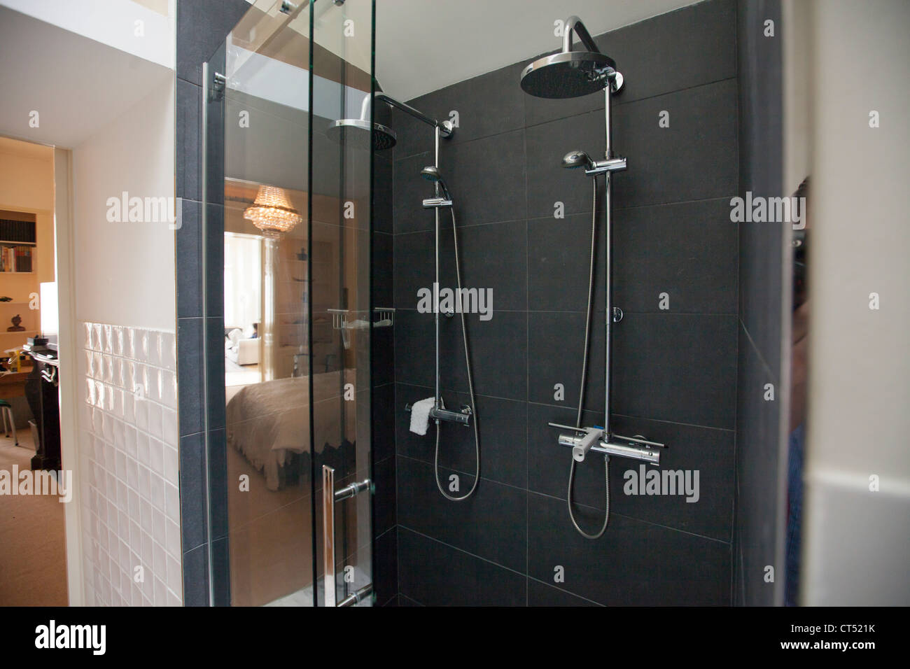 A modern a large shower, finished with granite and a large double shower head, His and hers. Stock Photo