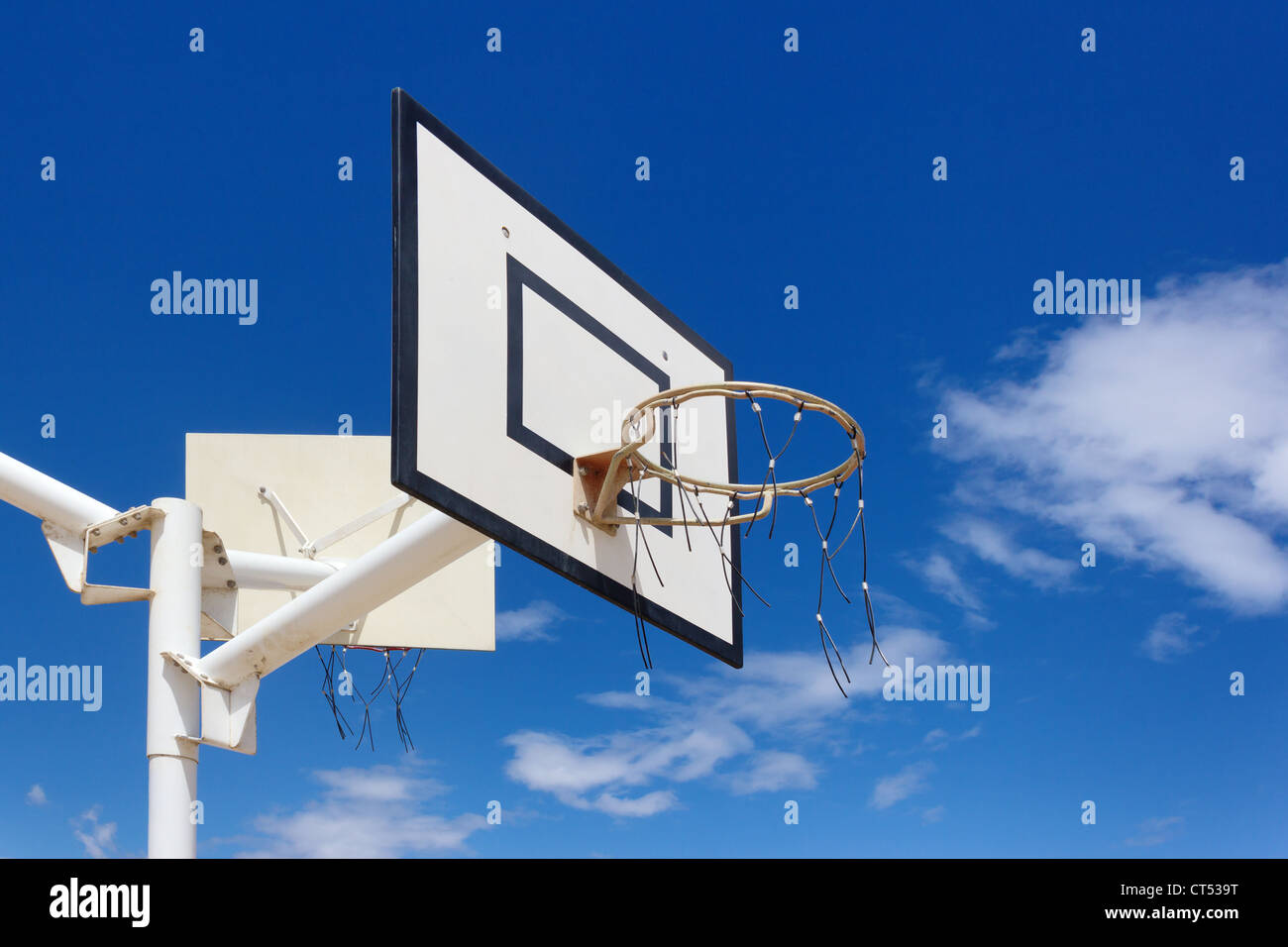 Outdoor basketball hoop under blue sky Stock Photo
