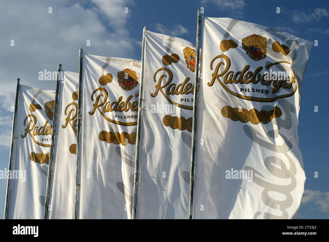 Flags with the Radeberger Pilsner logo in the wind Stock Photo