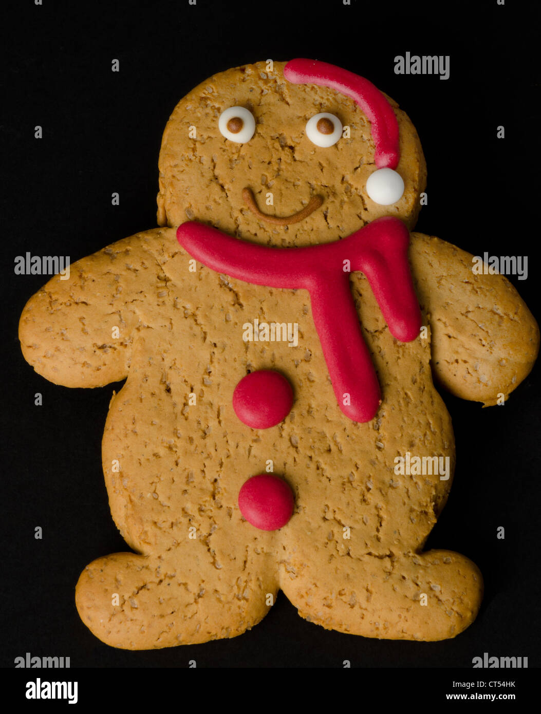 Gingerbread man with a Christmas red hat and scarf Stock Photo