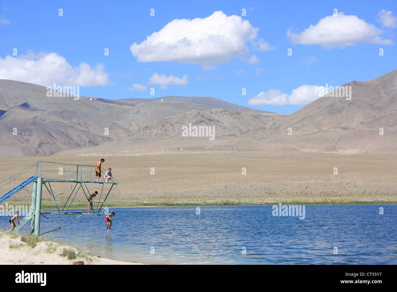 Children jumping into high plateau lake, Kosh-Agach, Altai, Siberia, Russia Stock Photo